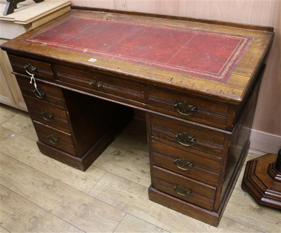 An Edwardian oak pedestal desk W.122cm